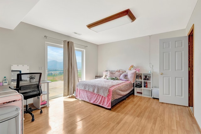 bedroom with access to outside and light hardwood / wood-style flooring