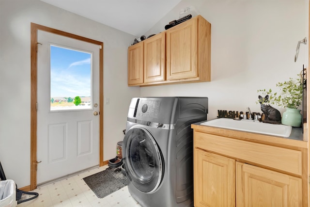 laundry area with cabinets, washer / dryer, sink, and light tile patterned floors