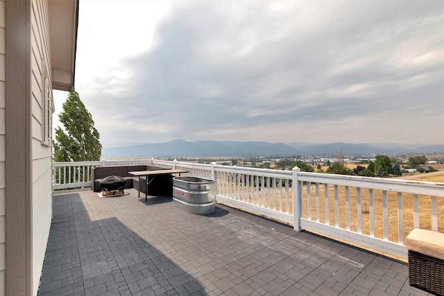 view of patio / terrace with a mountain view and a balcony