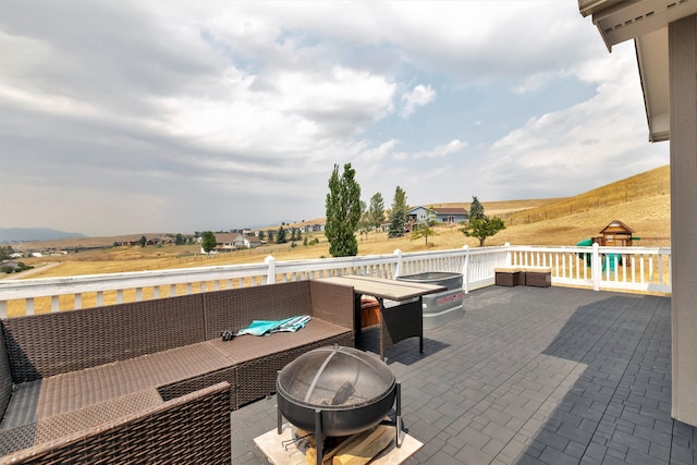 deck featuring a patio and an outdoor fire pit