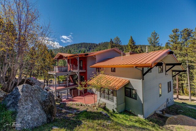 rear view of house featuring a deck with mountain view