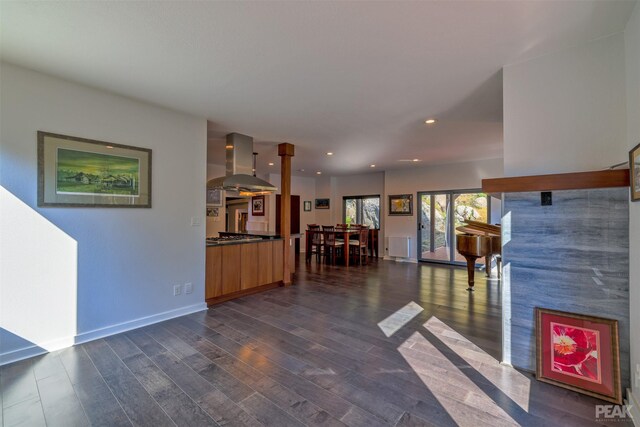 unfurnished living room with dark wood-type flooring