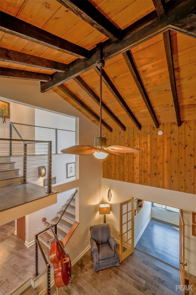 interior space featuring ceiling fan, hardwood / wood-style flooring, vaulted ceiling with beams, and wooden ceiling