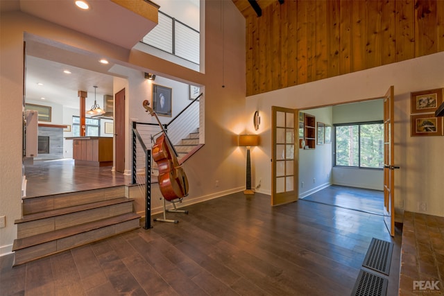 interior space featuring high vaulted ceiling, french doors, and dark hardwood / wood-style floors