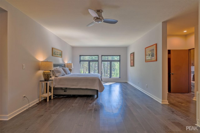 bedroom with dark wood-type flooring and ceiling fan