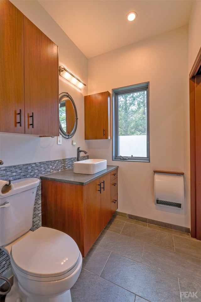 bathroom featuring tile patterned floors, vanity, decorative backsplash, and toilet