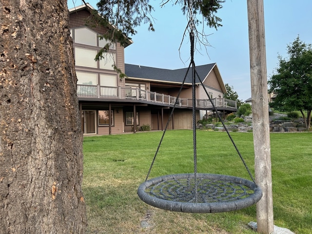 back of property featuring a yard and a wooden deck