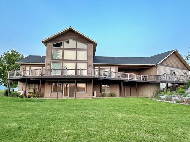 rear view of house with a wooden deck and a yard