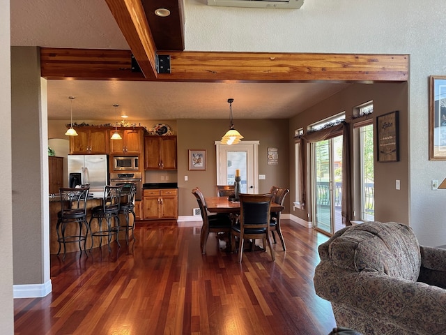dining space with baseboards, beamed ceiling, and dark wood-type flooring