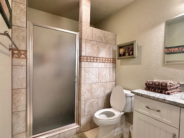 bathroom featuring vanity, toilet, and an enclosed shower