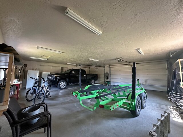 garage with freestanding refrigerator and a garage door opener