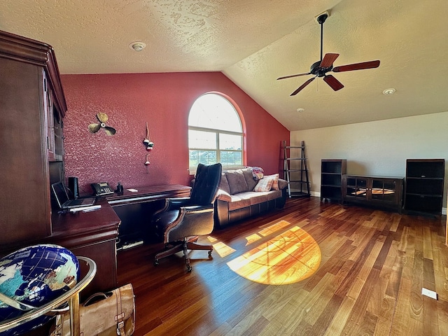 office featuring lofted ceiling, ceiling fan, dark hardwood / wood-style floors, and a textured ceiling