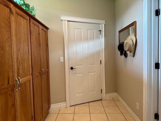 doorway with light tile patterned flooring