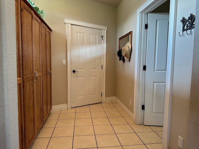 corridor with light tile patterned flooring