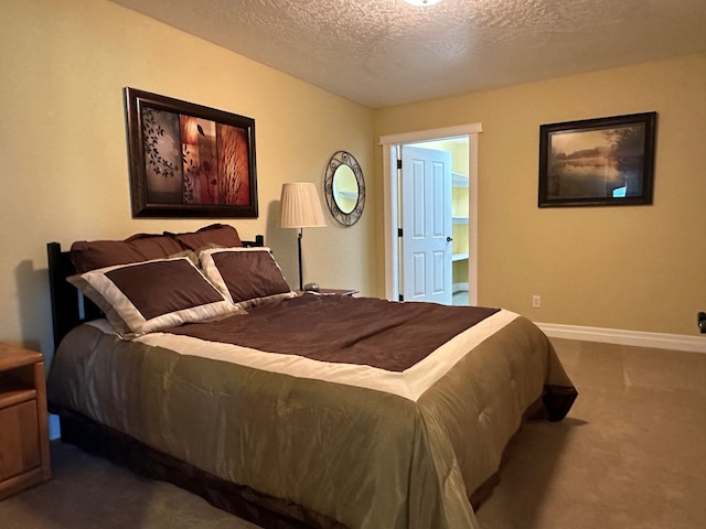 bedroom featuring a textured ceiling, baseboards, and dark colored carpet