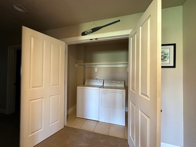 laundry room with laundry area, independent washer and dryer, light tile patterned flooring, and light carpet