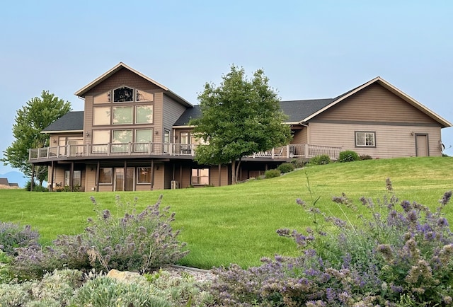 back of house featuring a lawn and a deck