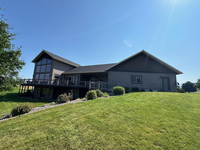 back of property featuring a yard and a deck