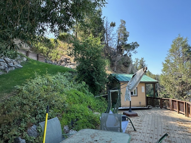 exterior space featuring a wooden deck and metal roof