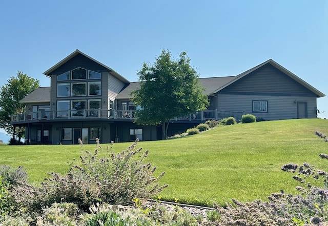 view of front of home featuring a front lawn and a wooden deck