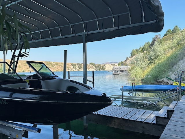 view of dock featuring a water and mountain view