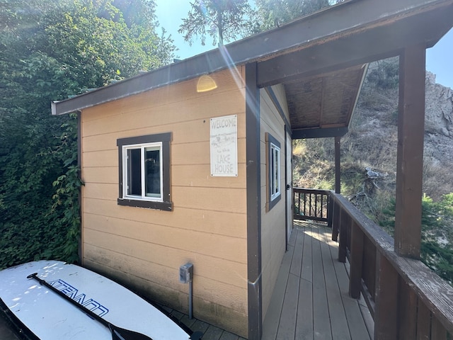 view of property exterior with a wooden deck