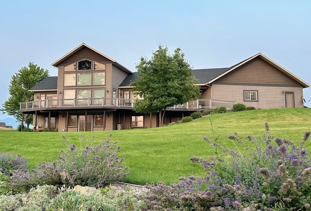 back of house with a wooden deck and a lawn