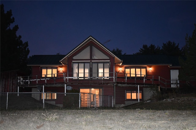 view of back house at twilight