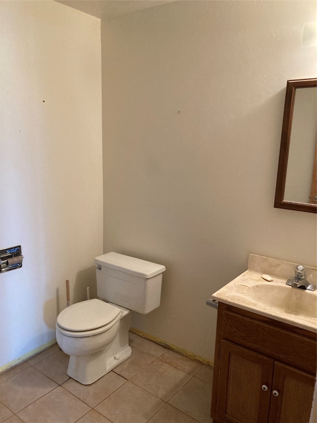 bathroom featuring toilet, vanity, and tile patterned floors