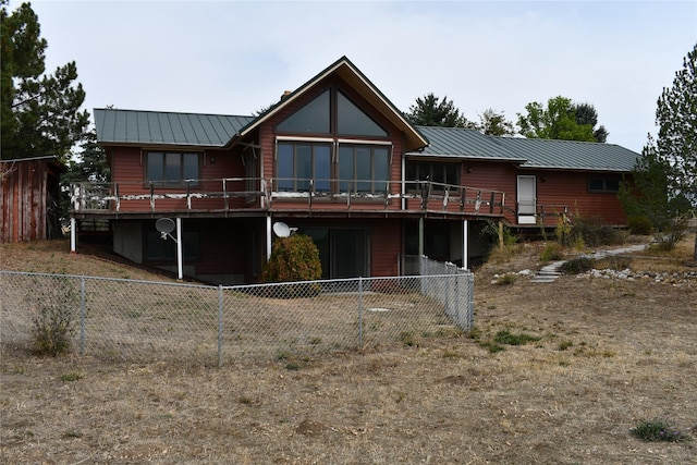 384 Eagle Ln, Corvallis, MT 59828 - back of property featuring a standing seam roof, a deck, a metal roof, and a fenced backyard