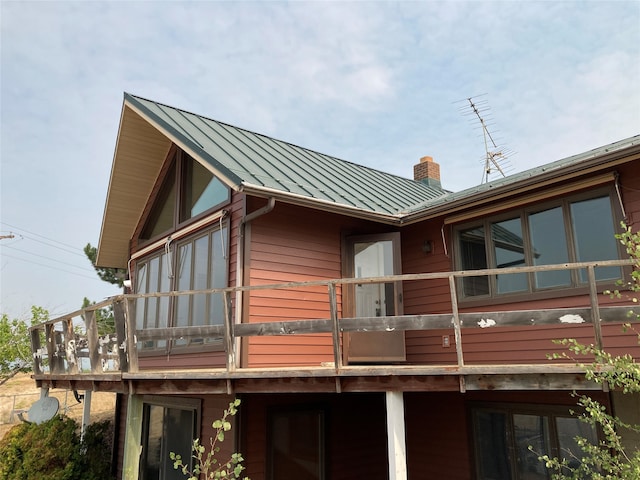 view of side of home featuring a balcony