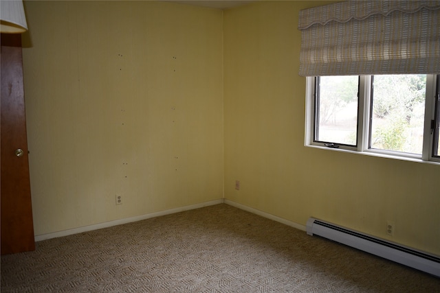 carpeted spare room with baseboard heating