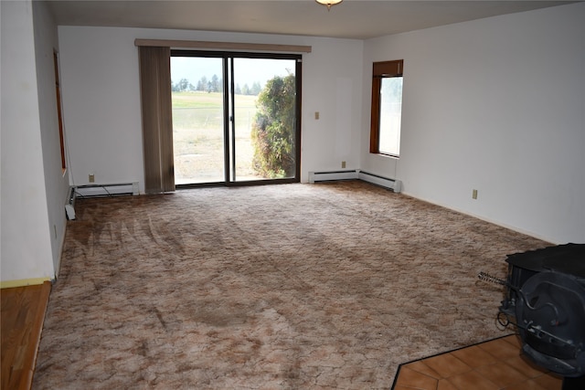 carpeted empty room featuring a baseboard radiator