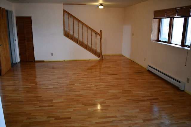 spare room with light hardwood / wood-style flooring and baseboard heating