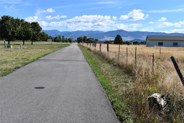 view of street with a rural view and a mountain view