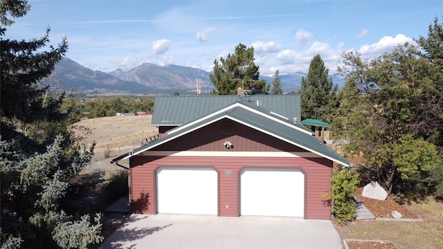 view of front of property featuring a mountain view and a garage