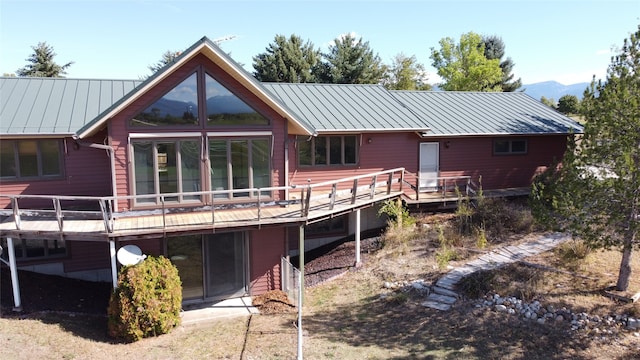 back of house with a deck with mountain view