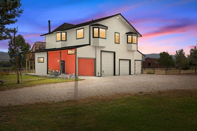 view of front of house featuring a garage and a lawn