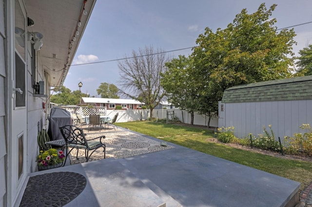 view of patio / terrace featuring grilling area and a storage shed