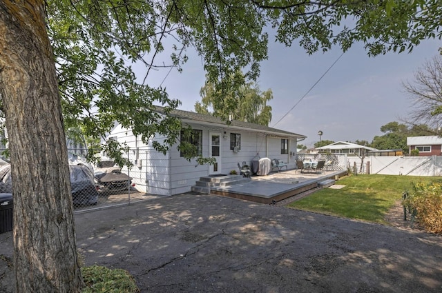 back of property featuring a yard and a deck