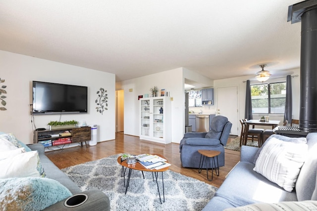 living room with dark hardwood / wood-style flooring and a wood stove