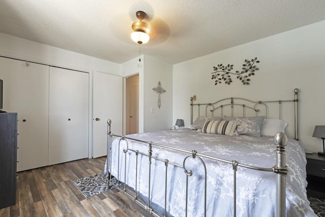 bedroom featuring dark hardwood / wood-style flooring, a textured ceiling, a closet, and ceiling fan