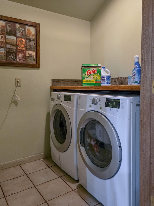 washroom featuring light tile patterned flooring and washer and clothes dryer