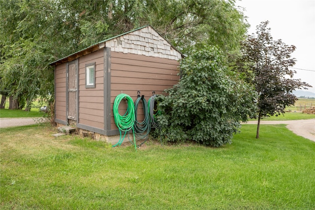 view of outdoor structure featuring a lawn