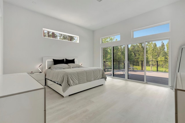 bedroom featuring access to outside and light hardwood / wood-style floors