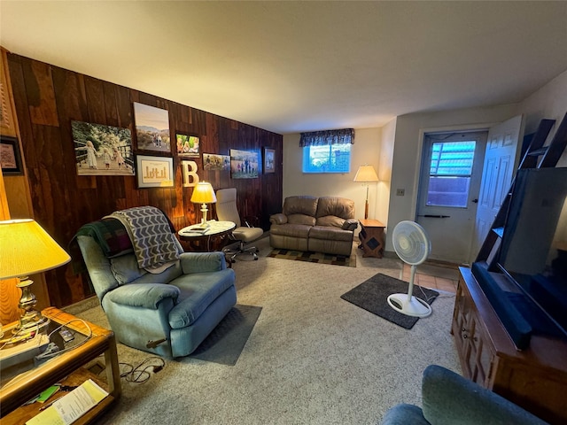 living room with carpet floors and wood walls