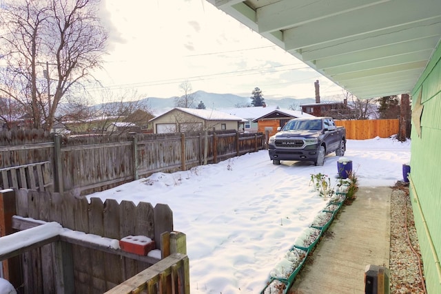 yard covered in snow with a mountain view