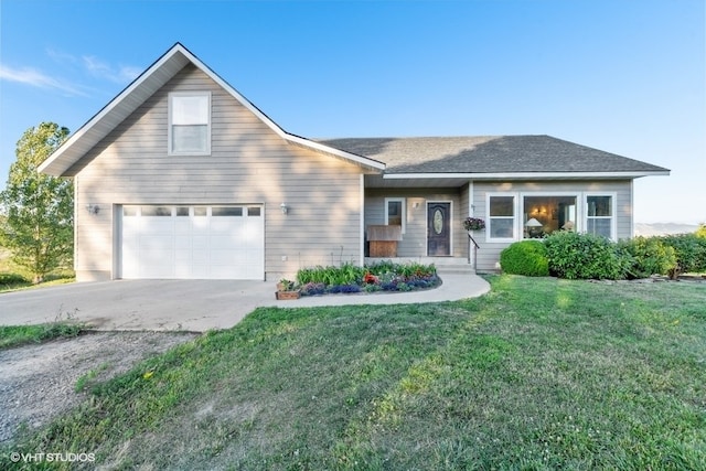 view of front of property featuring a garage and a front lawn