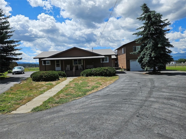 view of front of home featuring a garage and a porch