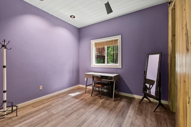 office space featuring baseboards, wooden ceiling, and wood finished floors
